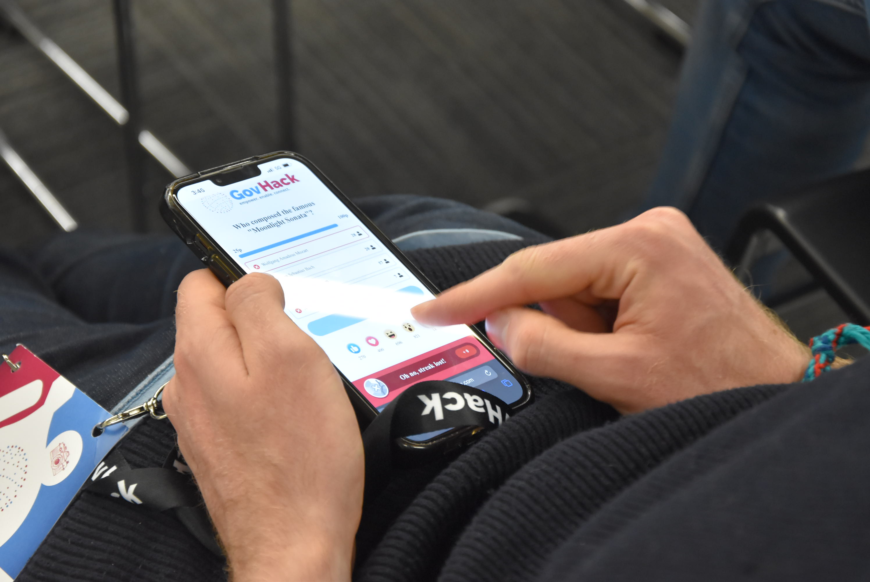 Person participating in GovHack Trivia on their phone
